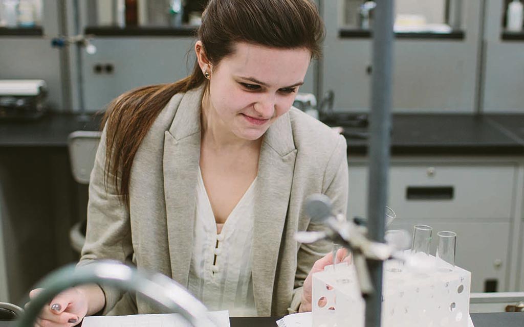 Female student holding a beaker in a science lab at Cornerstone University