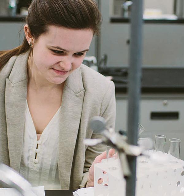 Female student holding a beaker in a science lab at Cornerstone University