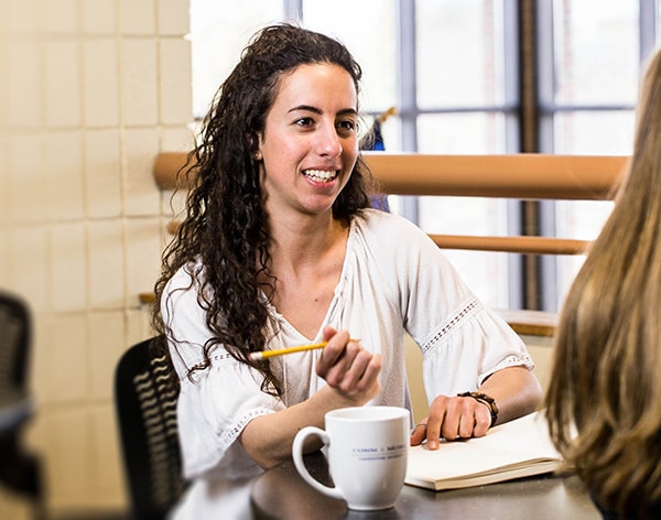Two Cornerstone students talking over coffee