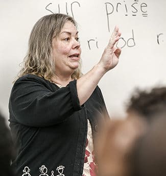 Female graduate student and educator teaching in an ESL classroom