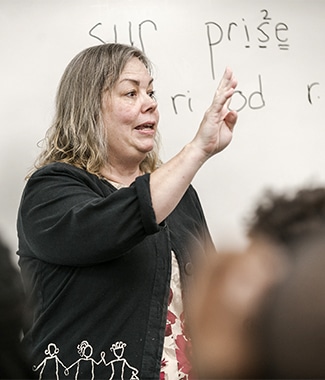 Female graduate student and educator teaching in an ESL classroom