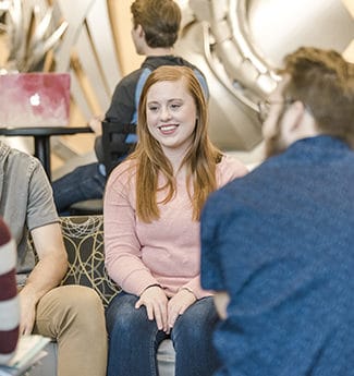 Group of undergraduate college students studying in the lobby of Christ Chapel at Cornerstone University