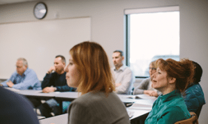 Students of gender diversity sitting in a classroom.