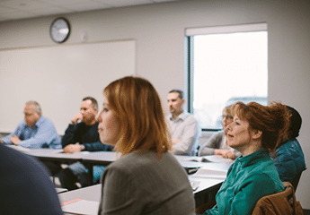 Students of gender diversity sitting in a classroom.