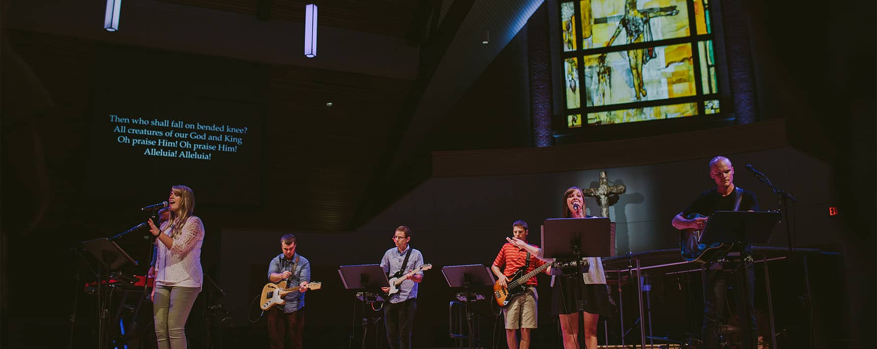 Worship team comprised of five undergraduate college students and one staff member leading worship on the stage in Christ Chapel at Cornerstone University