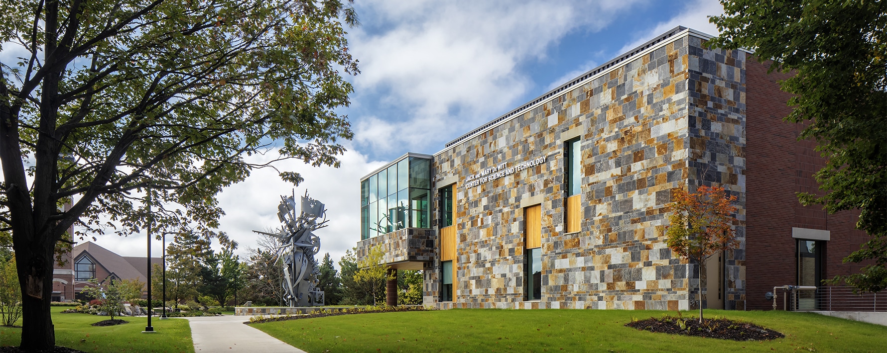 Exterior of De Wiitt Center for Science and Technology at Cornerstone University with Christ Chapel visible in the distance