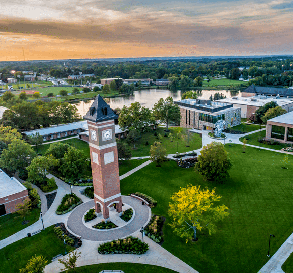 Aerial view of the Cornerstone University campus that shows academic buildings, bell tower and pond