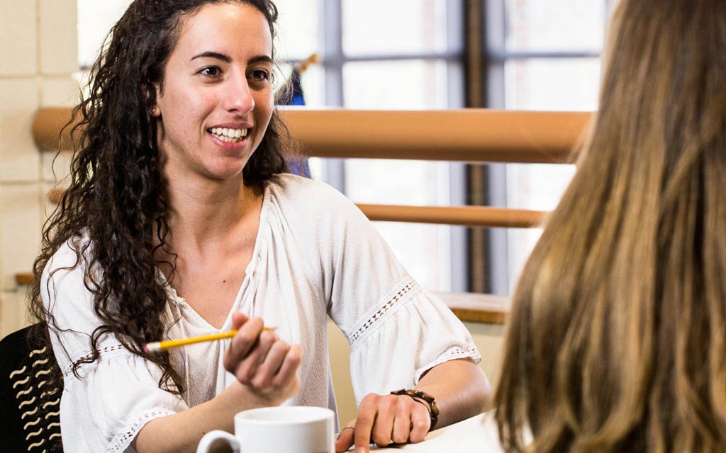 Female student taking notes in a meeting