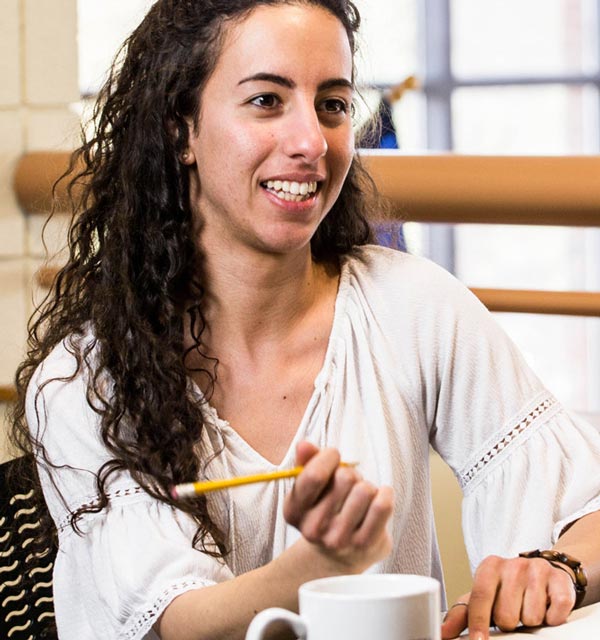 Female student taking notes in a meeting