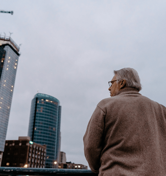 Male graduate student at Cornerstone University standing on a bridge in downtown Grand Rapids, Michigan