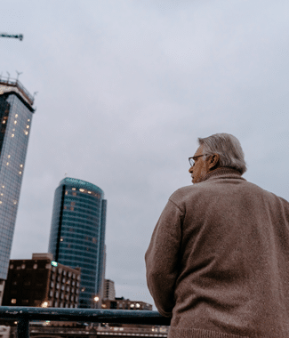 Male graduate student at Cornerstone University standing on a bridge in downtown Grand Rapids, Michigan