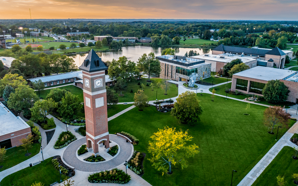 Aerial view of the Cornerstone University campus that shows academic buildings, bell tower and pond