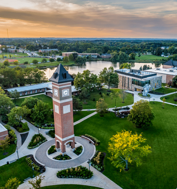 Aerial view of the Cornerstone University campus that shows academic buildings, bell tower and pond