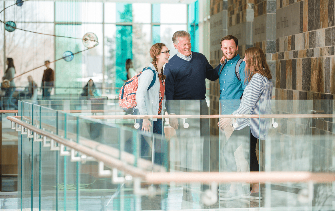 Joe Stowell talking with students in the atrium of De Witt Center for Science and Technology at Cornerstone University