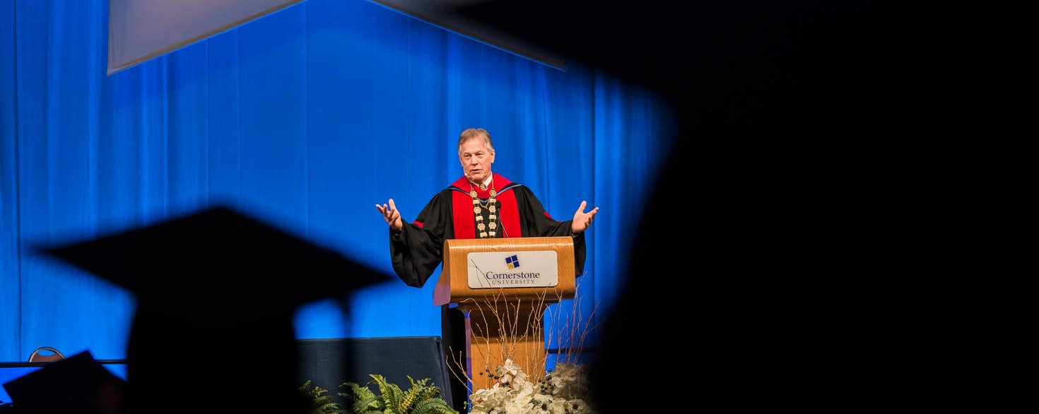 Joe Stowell speaking on stage at a Cornerstone University commencement ceremony