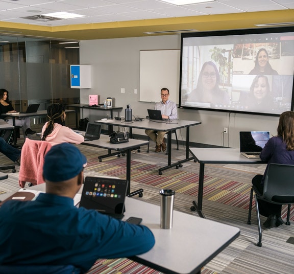 Livestreamed classroom with in-person and virtual students in a CULive classroom at Cornerstone University's Professional & Graduate Studies