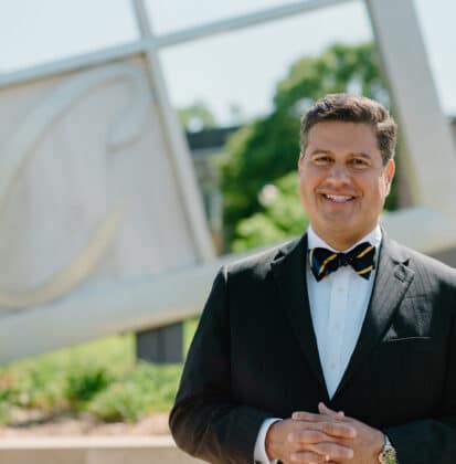 Gerson Moreno-Riaño with a sculpture of the Cornerstone University logo in the background