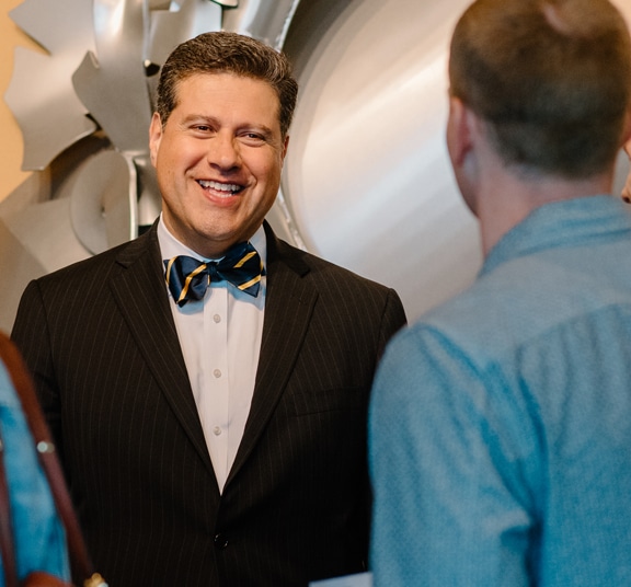 Gerson Moreno-Riaño smiling while talking with staff member