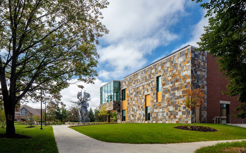 Exterior of De Wiitt Center for Science and Technology at Cornerstone University with Christ Chapel visible in the distance