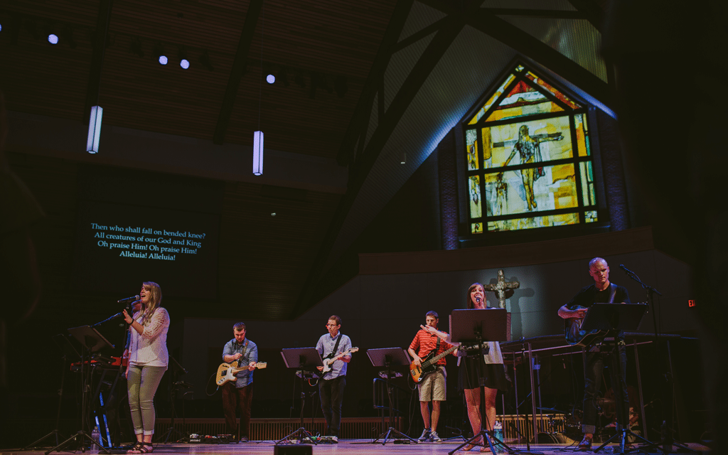 Worship team comprised of five undergraduate college students and one staff member leading worship on the stage in Christ Chapel at Cornerstone University