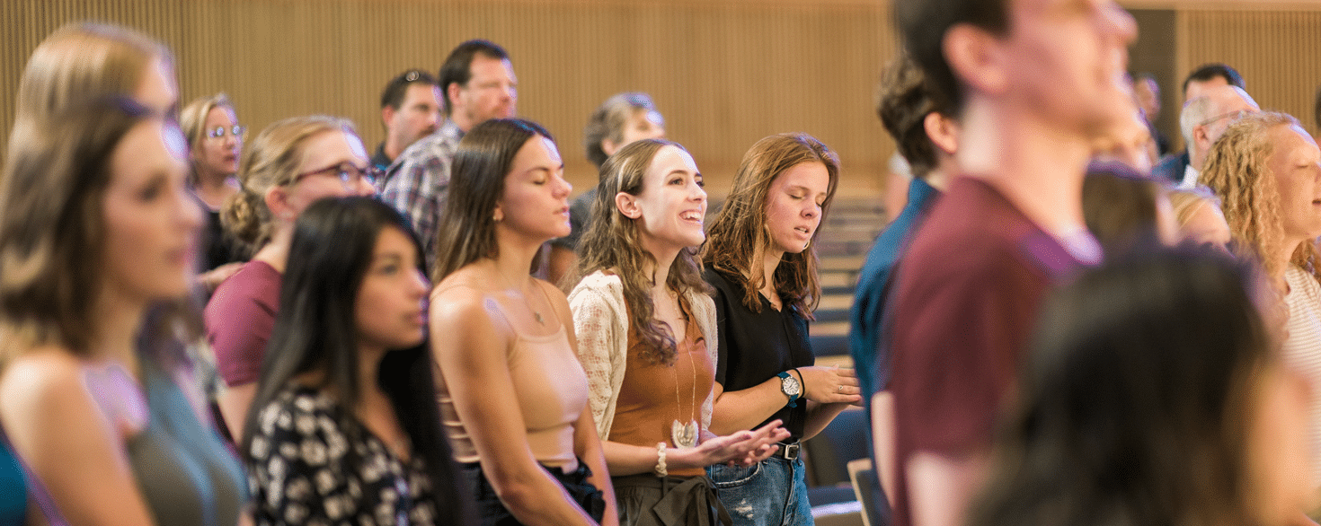 Undergraduate nursing students singing in Christ Chapel at Cornerstone University during Blessing of the Hands ceremony