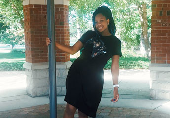 Female college student standing in campus gazebo