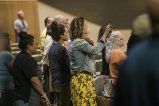 Families worshipping in Christ Chapel during the Blessing of the Hands at Cornerstone University