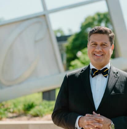 Gerson Moreno-Riaño with a sculpture of the Cornerstone University logo in the background