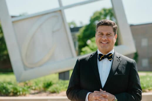 Gerson Moreno-Riaño with a sculpture of the Cornerstone University logo in the background