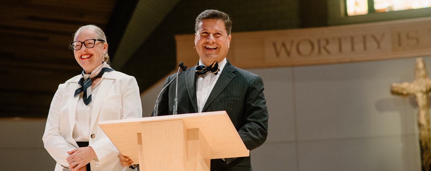 Gerson and Ellen Moreno-Riaño talking from the stage of Christ Chapel at Cornerstone University
