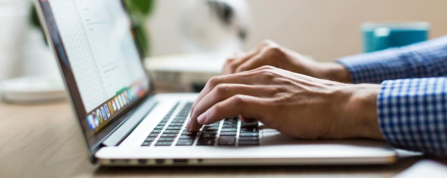 Male hands typing on a computer