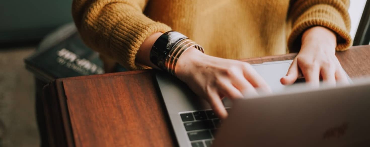 Female typing on a laptop at a desk