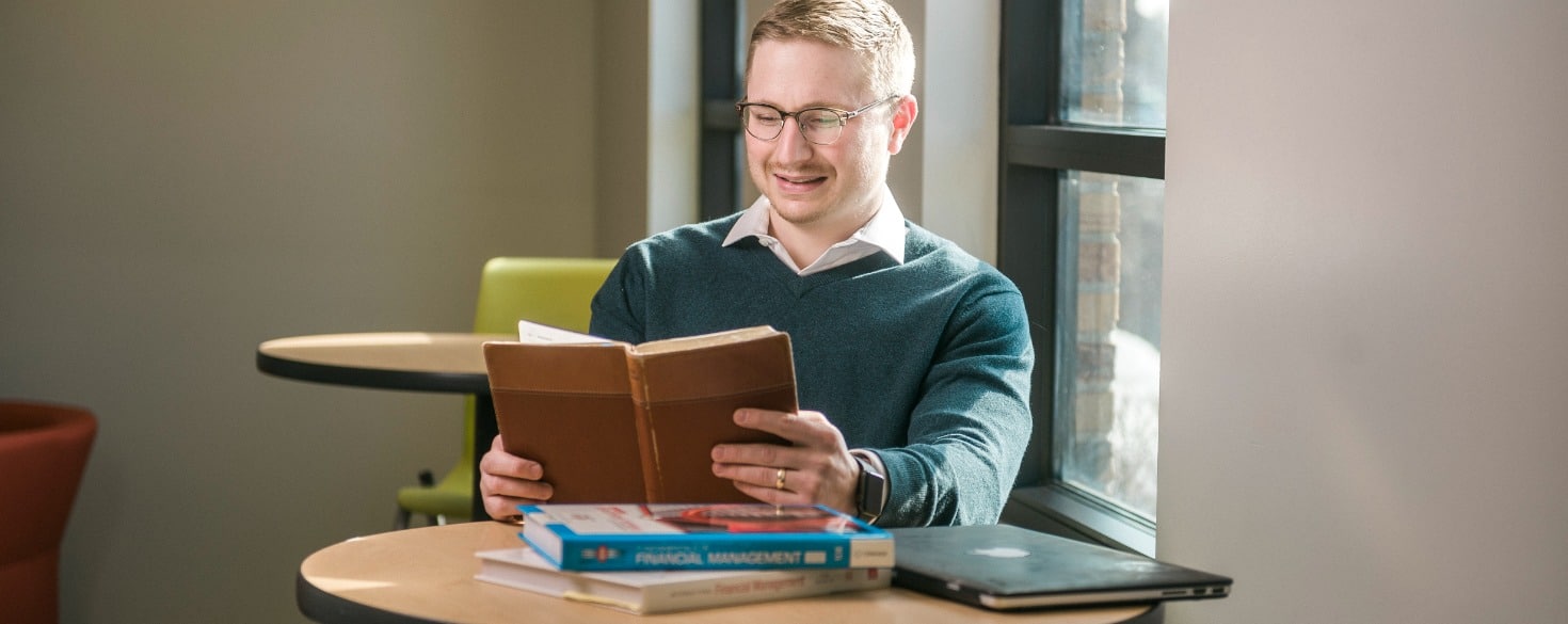 Male student reading at a table at Cornerstone University