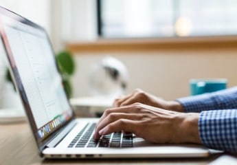 Male hands typing on a computer
