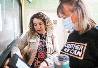 Two female workers discussing a solution to an assignment