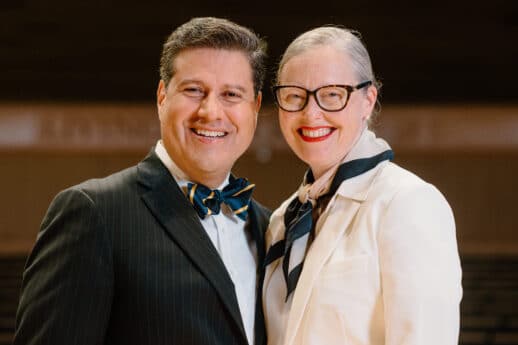 Gerson and Ellen Moreno-Riaño standing on the stage of Christ Chapel at Cornerstone University
