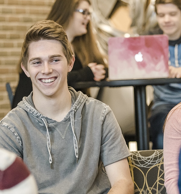 Male and female students talking in the lobby of Christ Chapel at Cornerstone University