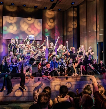 College students on auditorium stage in Matthews Performing Arts Center at Cornerstone University