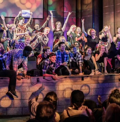 College students on auditorium stage in Matthews Performing Arts Center at Cornerstone University