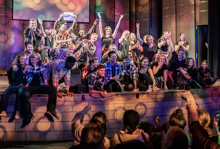 College students on auditorium stage in Matthews Performing Arts Center at Cornerstone University
