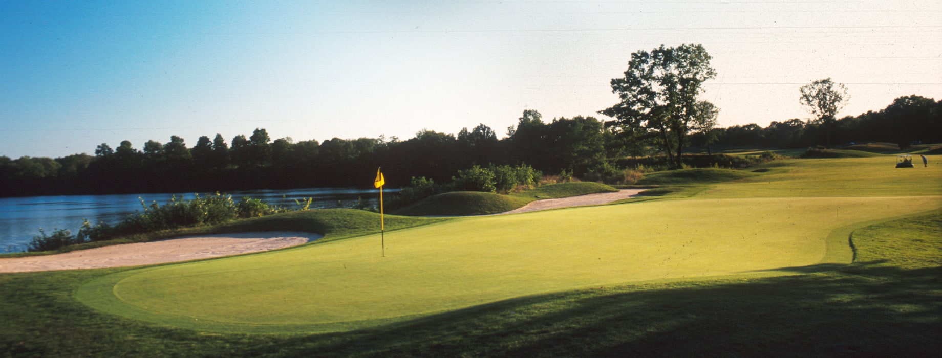 Golf course with a lake in the background