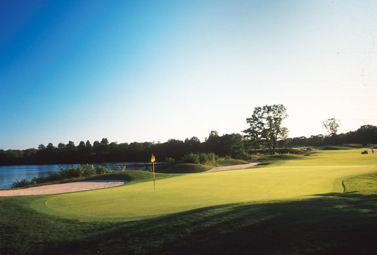 Golf course with a lake in the background