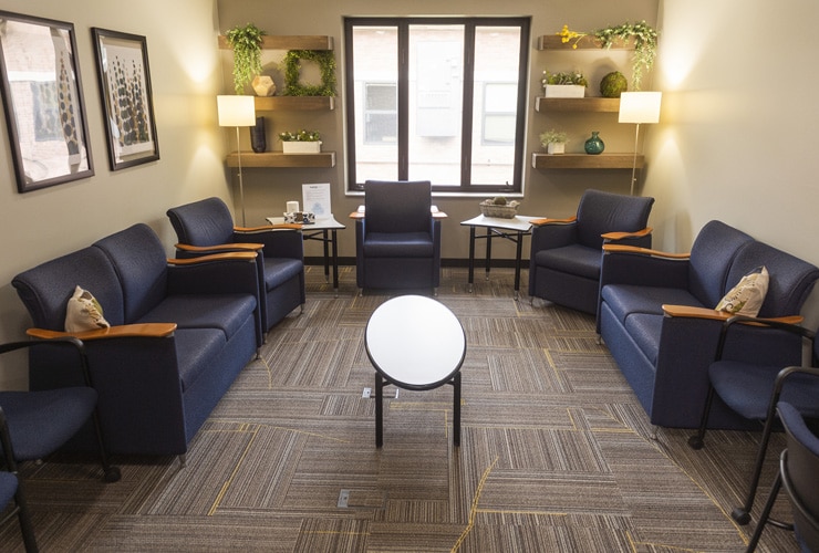 The Well counseling services office with couches and chairs, a window and coffee table