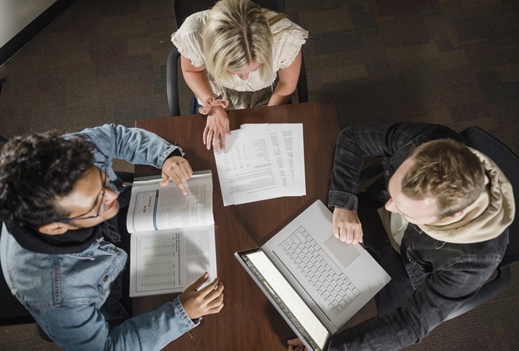 Aerial view of students studying from textbooks and a laptop at Cornerstone University