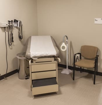 Medical office with an examining table, medical instruments and chair at Cornerstone University