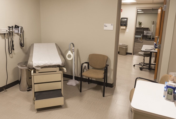 Medical office with an examining table, medical instruments and chair at Cornerstone University