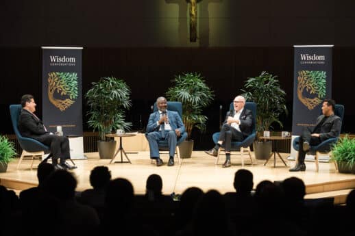 President Moreno-Riaño, Ian Rowe, Miroslav Volf and Samuel Rodriguez sitting on chairs in Christ Chapel while having a discussion in a front of an audience