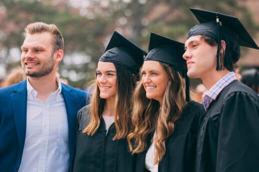 Male and two female graduates posing for a photo outside at Cornerstone University