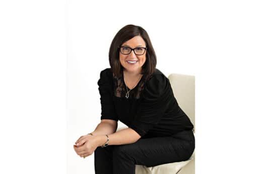 Female Amber MacKenzie sitting on chair