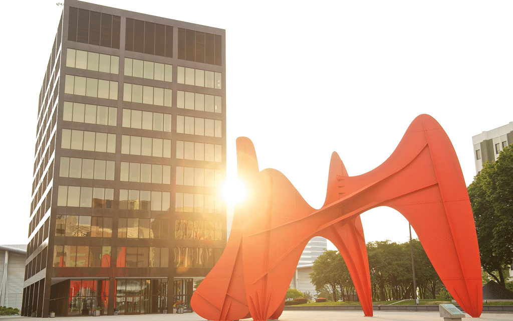 The sculpture La Grande Vitesse created by artist Alexander Calder located in downtown Grand Rapids with the setting sun in the background